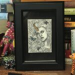 Pencil portrait of an unicorn girl with long hair surrounded by blue butterflies.