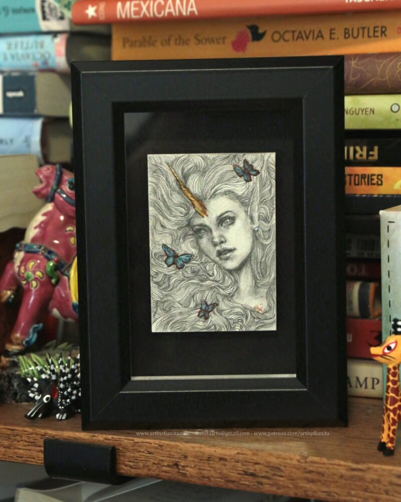 Pencil portrait of an unicorn girl with long hair surrounded by blue butterflies.