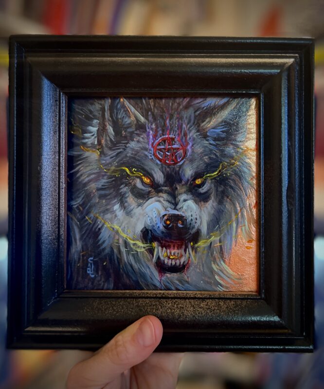 snarling wolf wearing pentagram in a frame