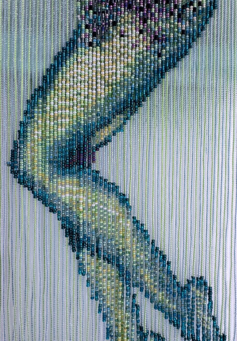 Reverse mermaid - salmon head created with sequin film and shell atop beaded fringe legs