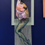 Reverse mermaid - salmon head created with sequin film and shell atop beaded fringe legs