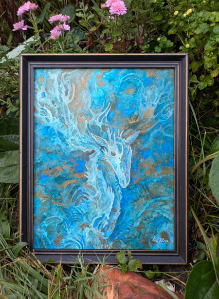 Photo of a painting of a deer in a frame. it is surrounded by plants outside.