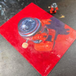 red robot and toy by Aaron Miller