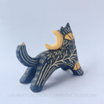 An angle of the sculpture that shows 3/4 of the back.