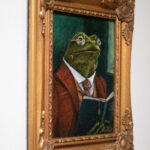 Framed original painting Professor Percival Croakley by artist Connie Resch, Renaissance-style frog portrait in ornate gold frame, hanging on a wall as home or office art decor.