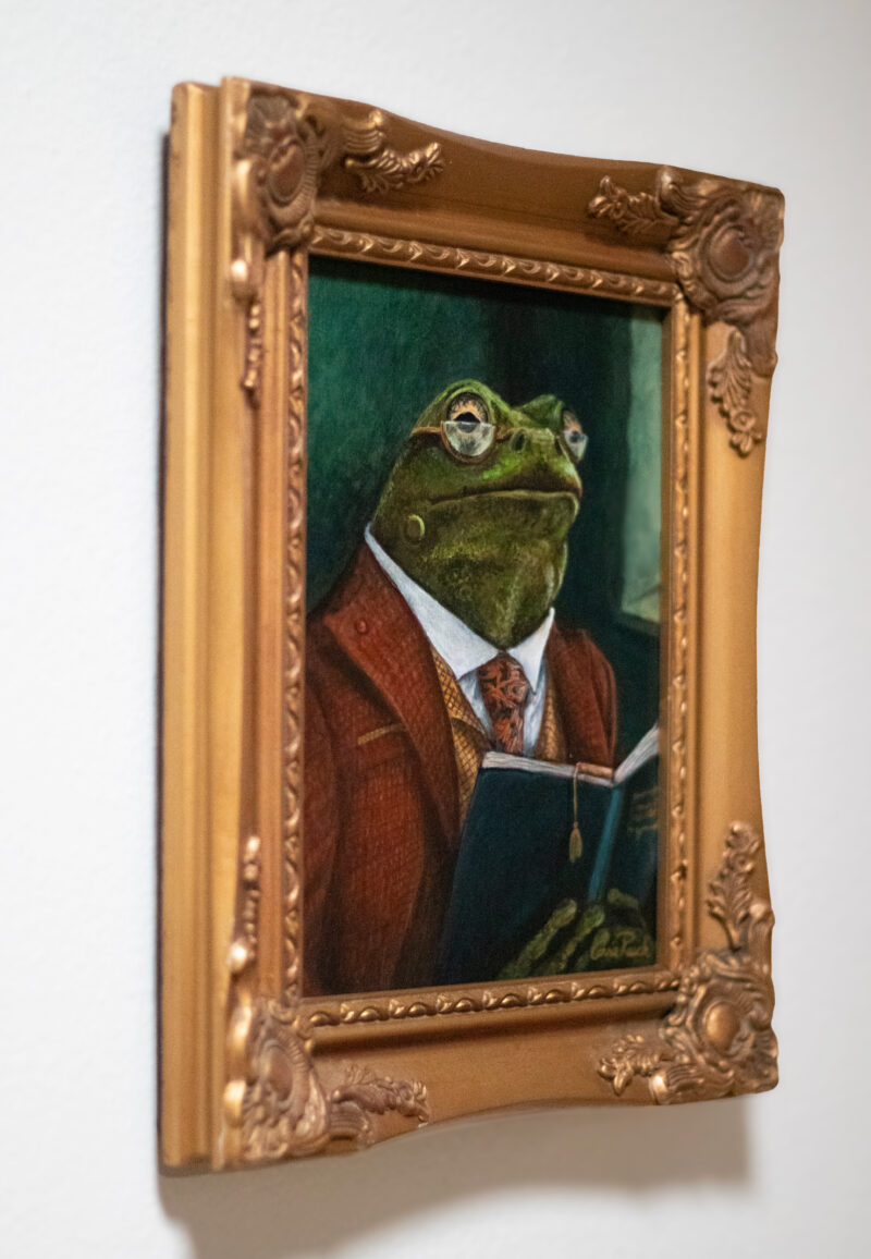 Framed original painting Professor Percival Croakley by artist Connie Resch, Renaissance-style frog portrait in ornate gold frame, hanging on a wall as home or office art decor.