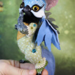 original art doll of a bluetit mixed with a cat standing on its hind paws made by Svetlana Polupanova