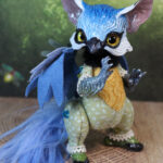 original art doll of a bluetit mixed with a cat standing on its hind paws made by Svetlana Polupanova