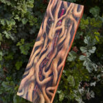 A painting of a forgotten, rusted sword slowly being devoured and deformed by the forces of nature.