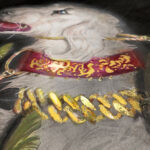 Detail view of a fantasy borzoi adorned in shining gold caught in a cameras bright flash while standing in tall grass. painting on a Quatrefoil found object.