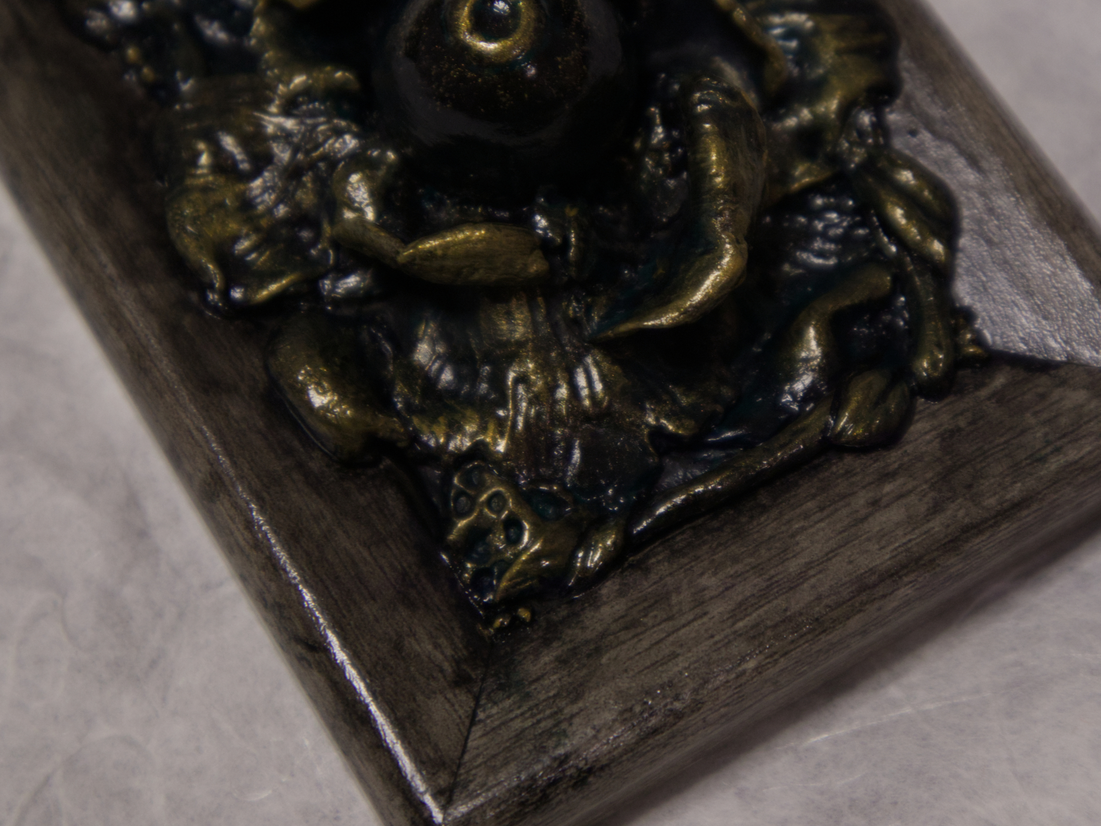 A photo of a sculpture of an eye surrounded by petals, branches, and leaves.