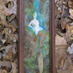 Framed painting of a pale dryad woman in roots and tree. Blue surrounds her, like light is coming from a split open trunk. She has a long piece of fabric draped from her legs.