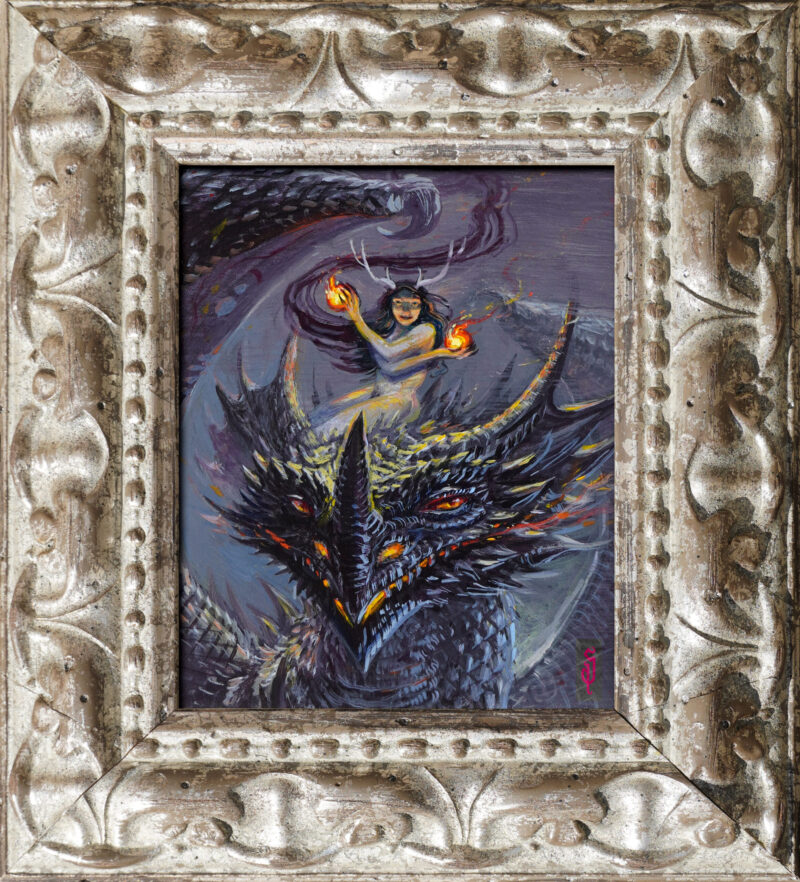 A framed picture of a fire fairy riding a dragon