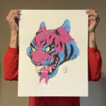 An image of the artist holding the acrylic painting on watercolor paper of a