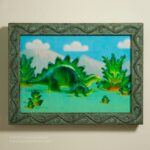 framed painting on wall of a green and yellow gummie candy adult stegosaur eats a gummie candy fern and a gummie candy baby stegosaur looks up under a blue sky with mountains a puffy white gummie candy clouds