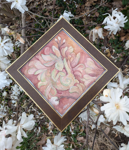 Watercolor painting of a bunny in soft pinks and greens, framed in brown wood, with magnolia flowers around it.