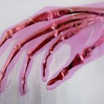 Golden skeletal hand elegantly posed