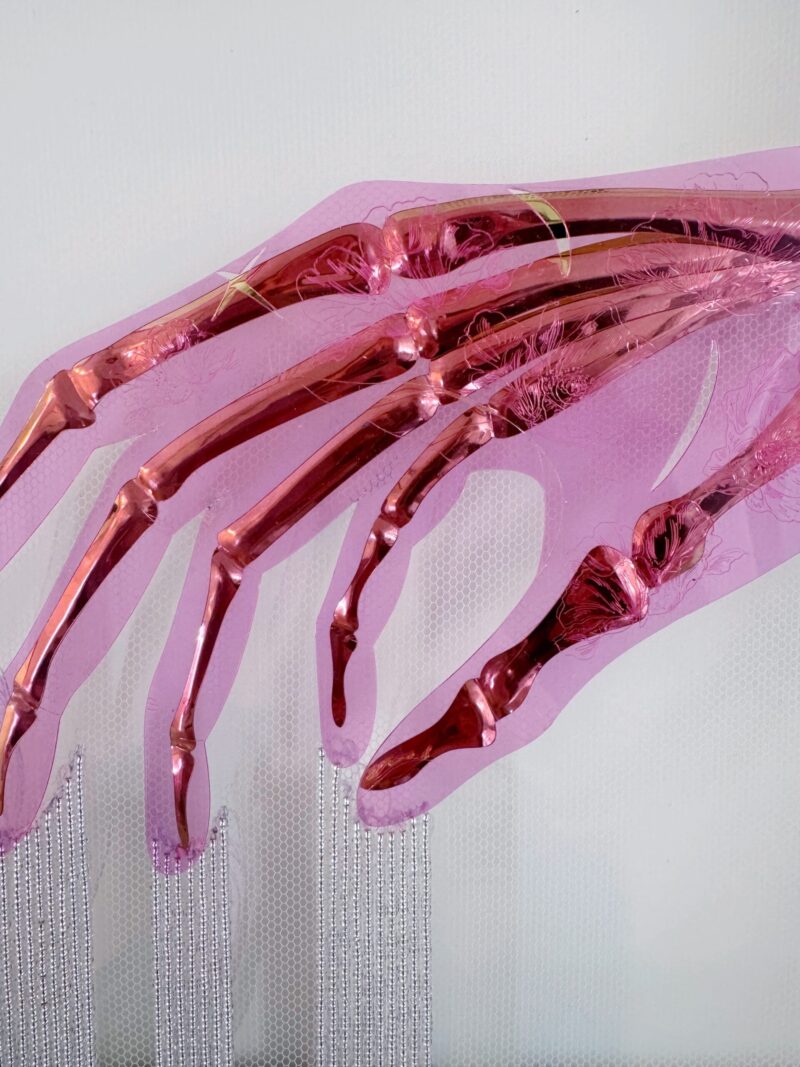 Golden skeletal hand elegantly posed