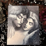 Statue Lovers painting surrounded by vintage fabric, flowers, and a frame in my studio