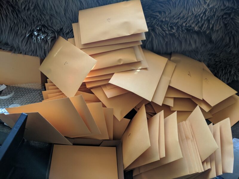 A pile of pins from Laura Garabedian's Kickstarter packaged for shipping.