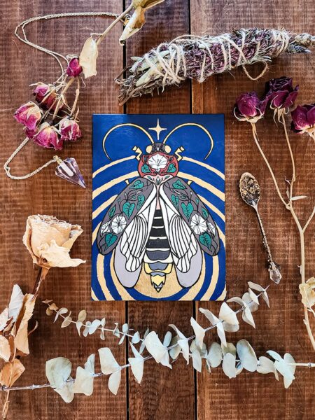 An acryla gouache painting of a lightning bug with gold leaf emanating from its glowing end. The lightning bug is on a blue background and has images of a moonflower plant drawn over its wings and body.
