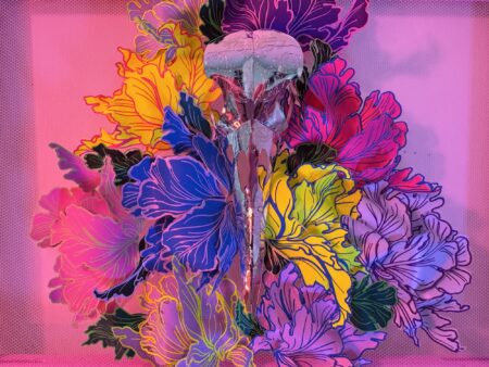 A hand-sculpted silver filigree bird skull nestled in a riot of colourful 3d flowers, hand-stitched to the frame
