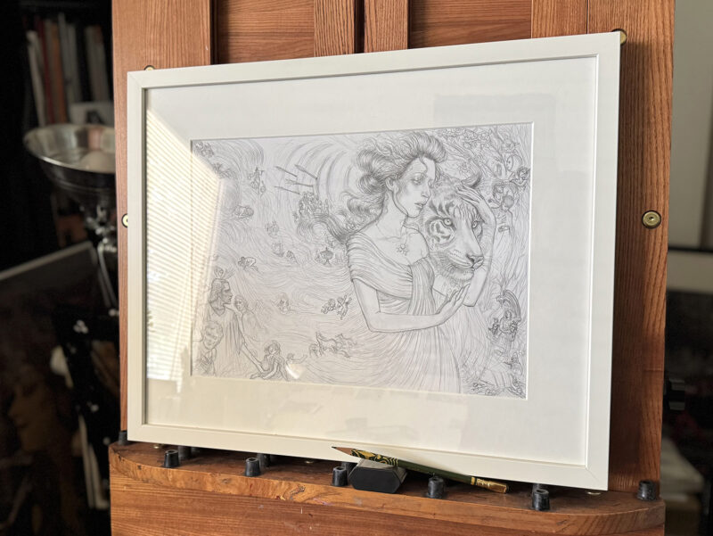 A side shot of framed "Strength" Drawing on a mahogany easel.