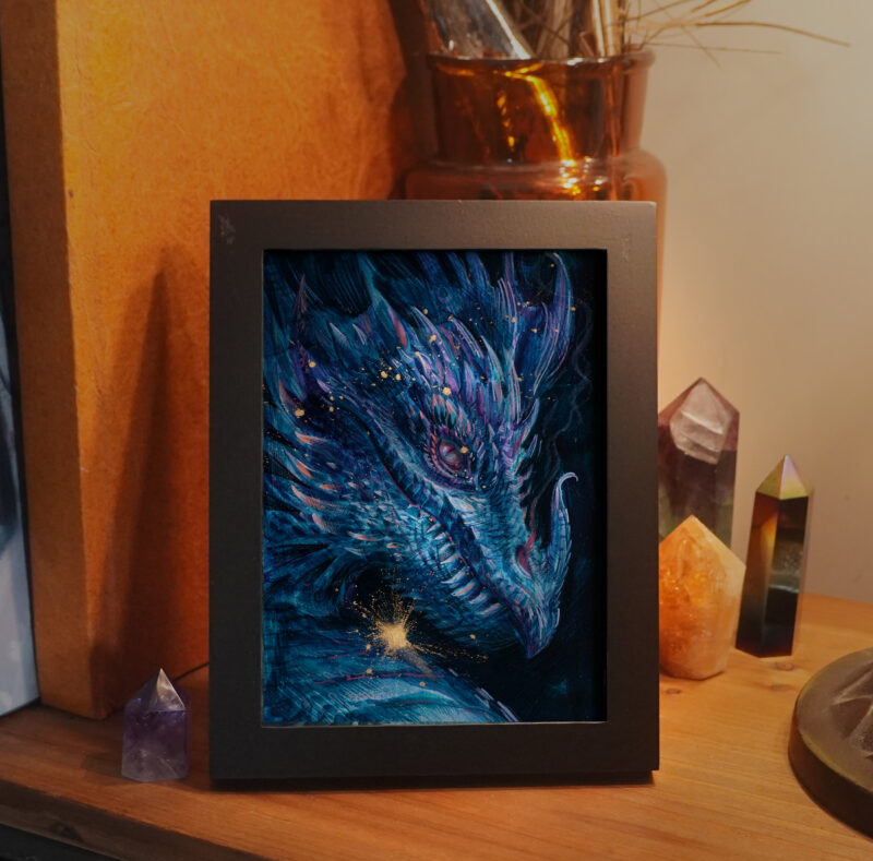 A framed painting illustrating a portrait of a golden cyan dragon