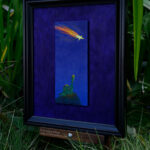 side view of a framed oil painting of a green gummie candy brontosaurus standing on a grassy hill at night staring up into a deep blue sky at a falling star on a purple background photographed in a garden