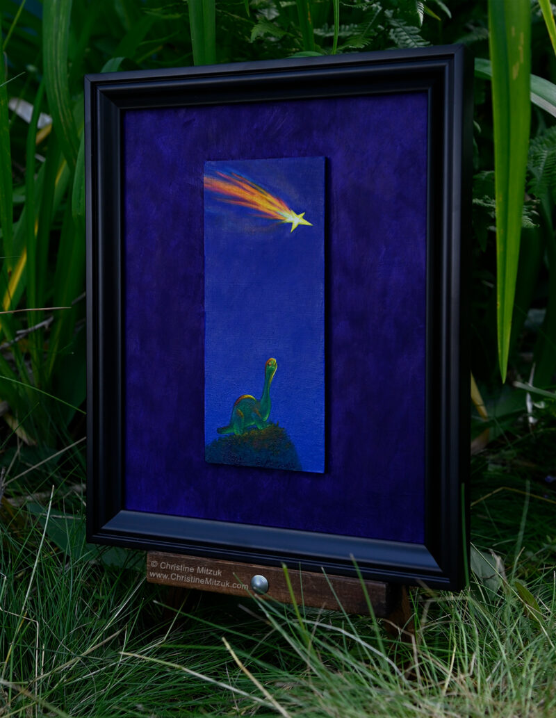 side view of a framed oil painting of a green gummie candy brontosaurus standing on a grassy hill at night staring up into a deep blue sky at a falling star on a purple background photographed in a garden