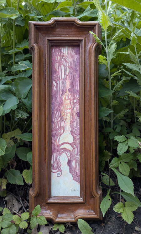 Painting in a narrow frame set on some leaves to display. It is a pink and orange abstract landscape of sunset.