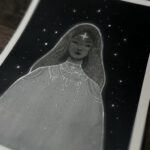 A painting of a feminine figure in white clothing, a star on her forehead, and silver and glittery details. The figure is placed against a dark background with stars.