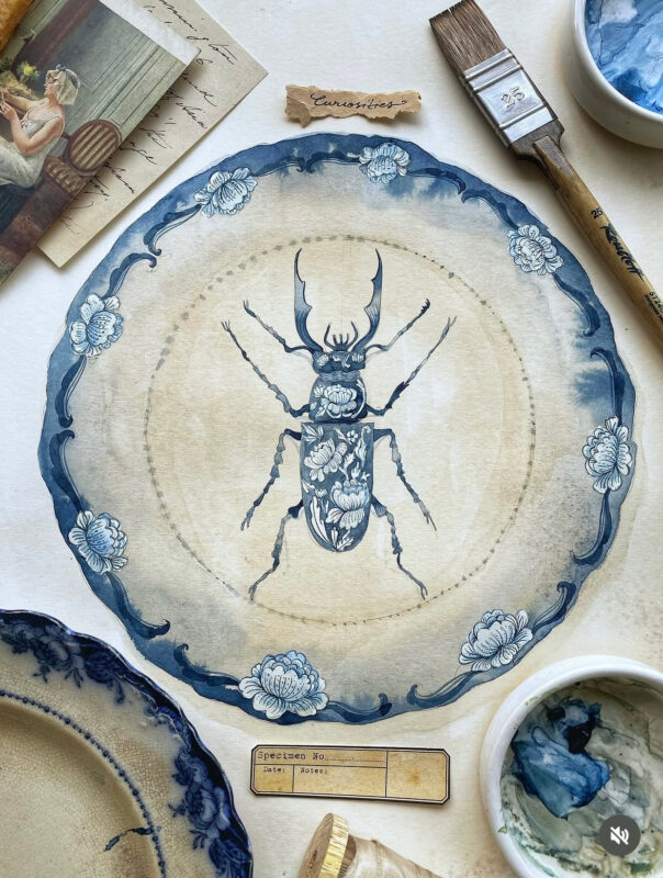 A hand-painted blue-and-white porcelain-style plate featuring intricate floral and vine motifs with a detailed beetle at the center. Inspired by antique Chinese ceramics and natural history collections, the artwork evokes the feeling of a treasured object displayed in a collector's cabinet of curiosities. The plate is photographed against a neutral background.