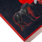 Corner view of the painting with a red edge.