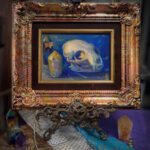 A framed oil painting of a cat skull with rainbow and citrine crystals