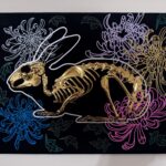 A golden bunny skeleton rests inside a burrow of chrysanthemums