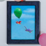 a red and yellow gummie candy pterosaur flying with a purple gummie candy dino brontosaur hanging on to the string of a green balloon floating in a blue sky with pale white clouds