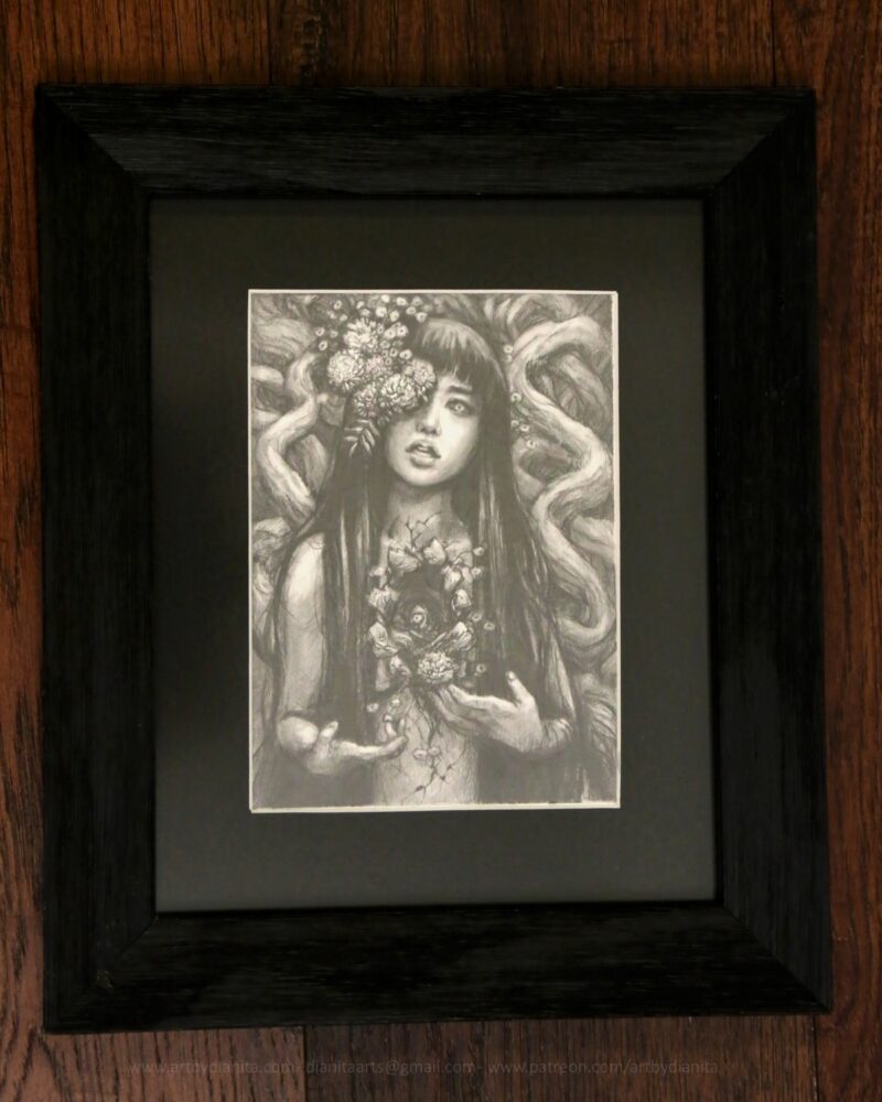 Graphite drawing of a female representing figure with marigolds coming out of one of her eyes. Long dark hair. Chest open, edges look like bark. A marigold comes out of the space. Tree branches at her back.