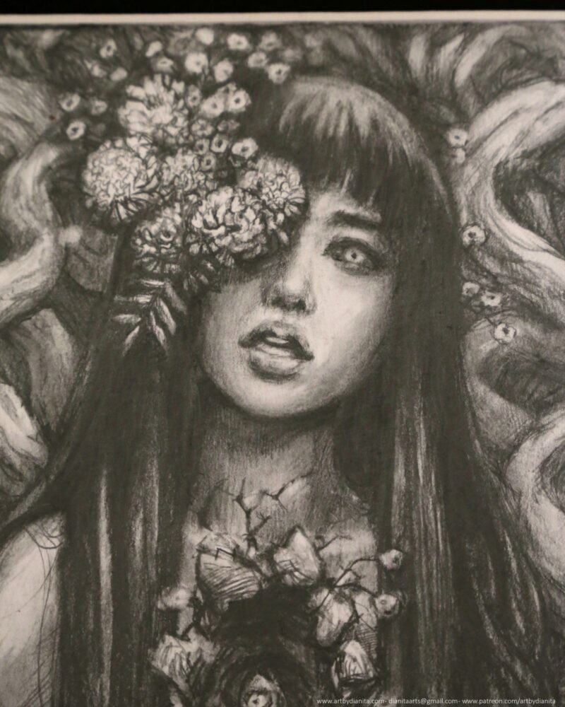 Graphite drawing of a female representing figure with marigolds coming out of one of her eyes. Long dark hair. Chest open, edges look like bark. A marigold comes out of the space. Tree branches at her back.