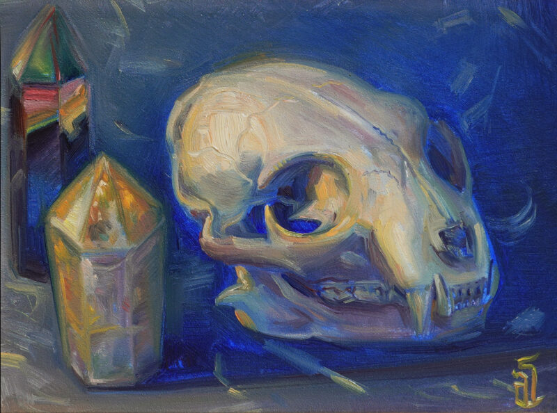 A framed oil painting of a cat skull with rainbow and citrine crystals
