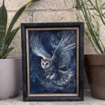 Night Messenger, a framed mystical owl painting displayed beside two potted plants.