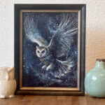 Night Messenger, a framed mystical owl painting displayed on a table, showing the artwork in a home setting.