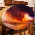 ‘Pax Exitiosa’, a tondo oil painting on a pochade, on an angle. Includes an image of a cloud of smoke and fire on a beach.