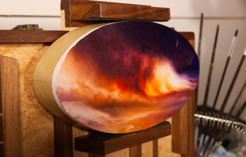 ‘Pax Exitiosa’, a tondo oil painting on a pochade, on an angle. Includes an image of a cloud of smoke and fire on a beach.